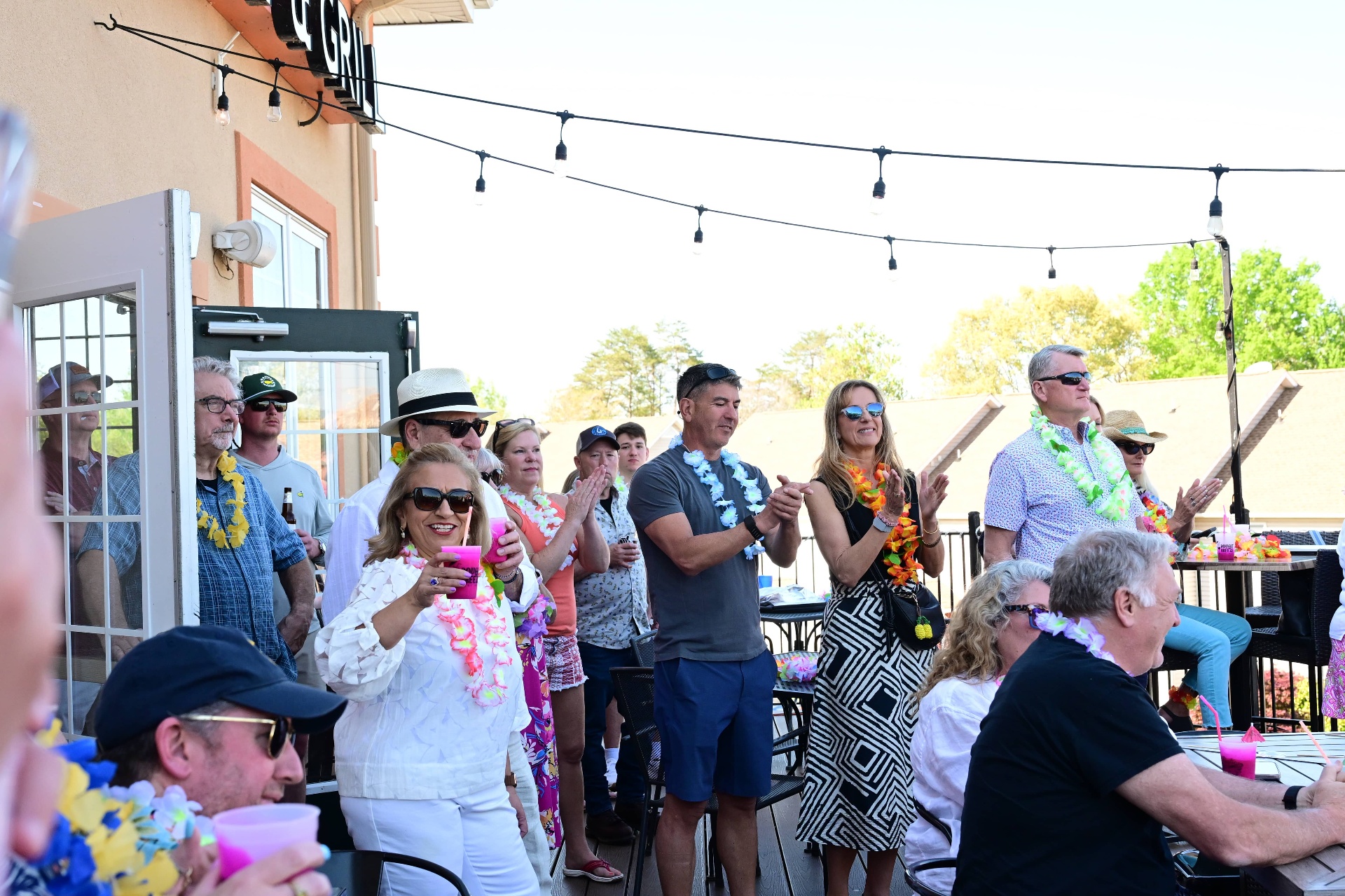 Crowd cheering at the ribbon cutting
