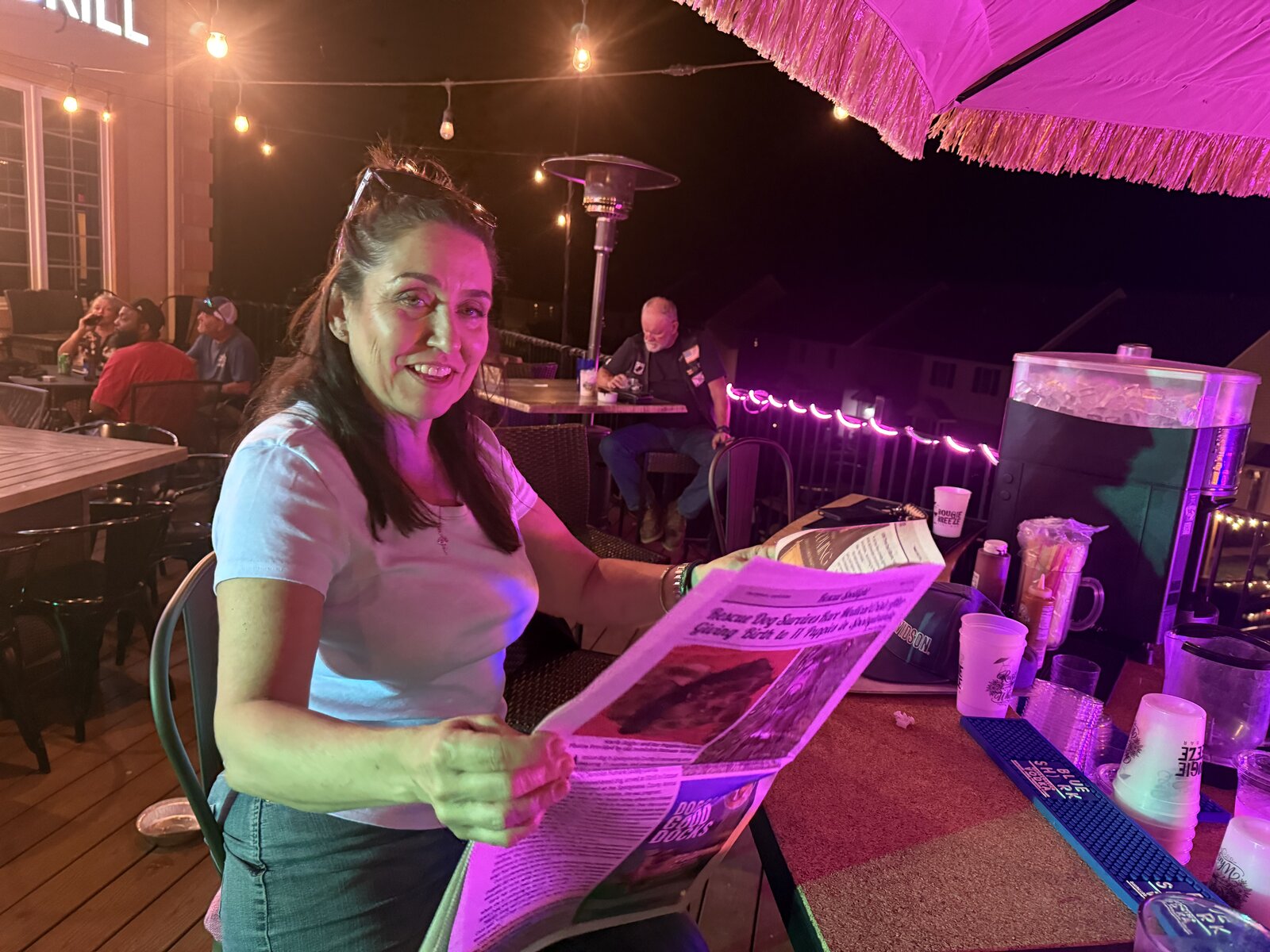 Guest reading The Lake Anna Breeze at the bar