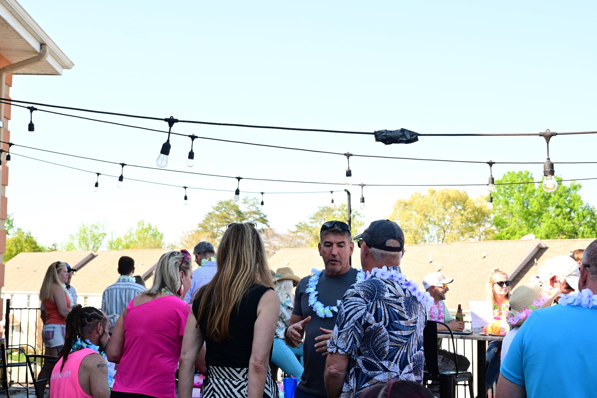 Guests under string lights on the patio