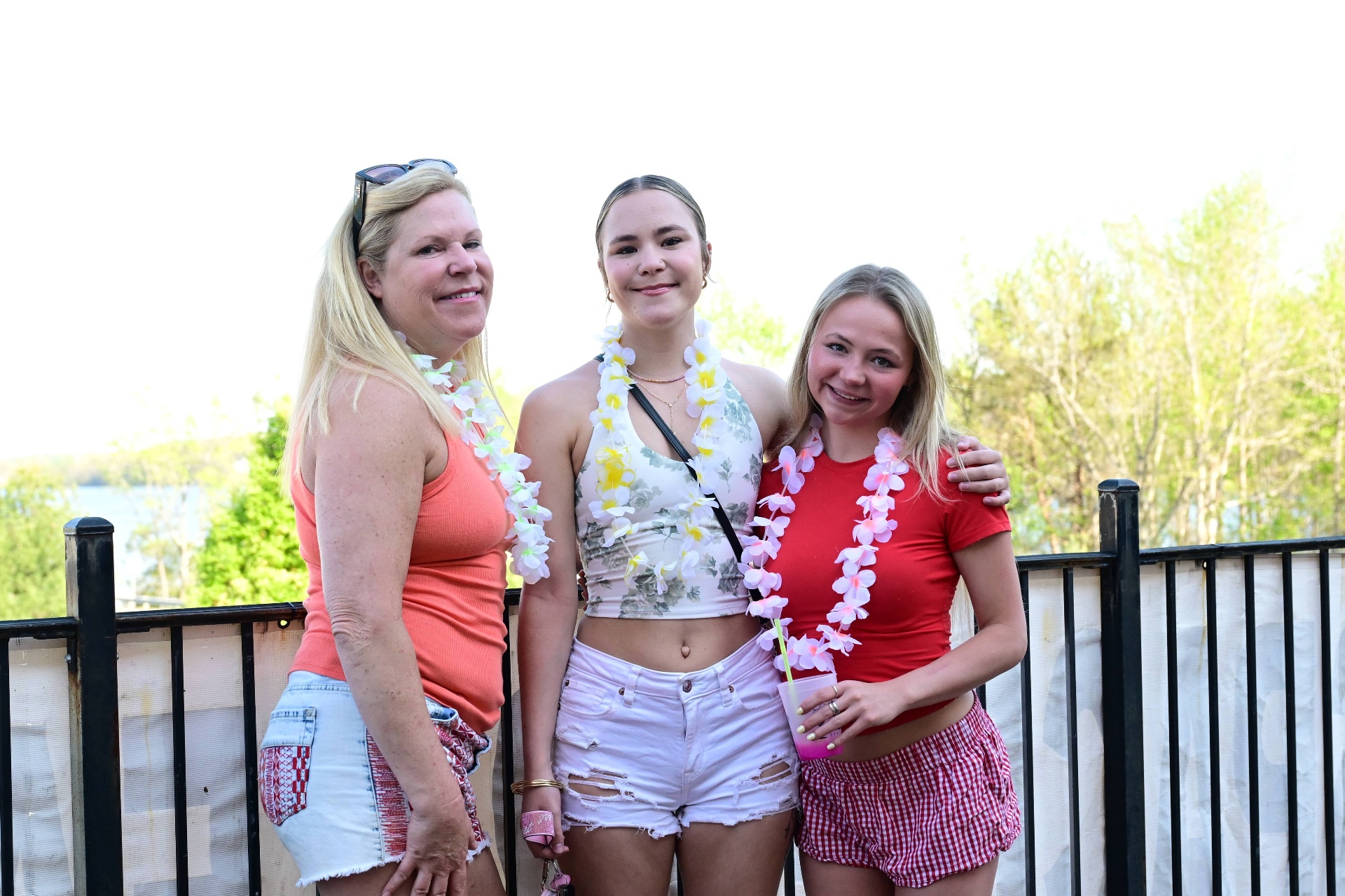 Three friends with leis at Bougie Breeze